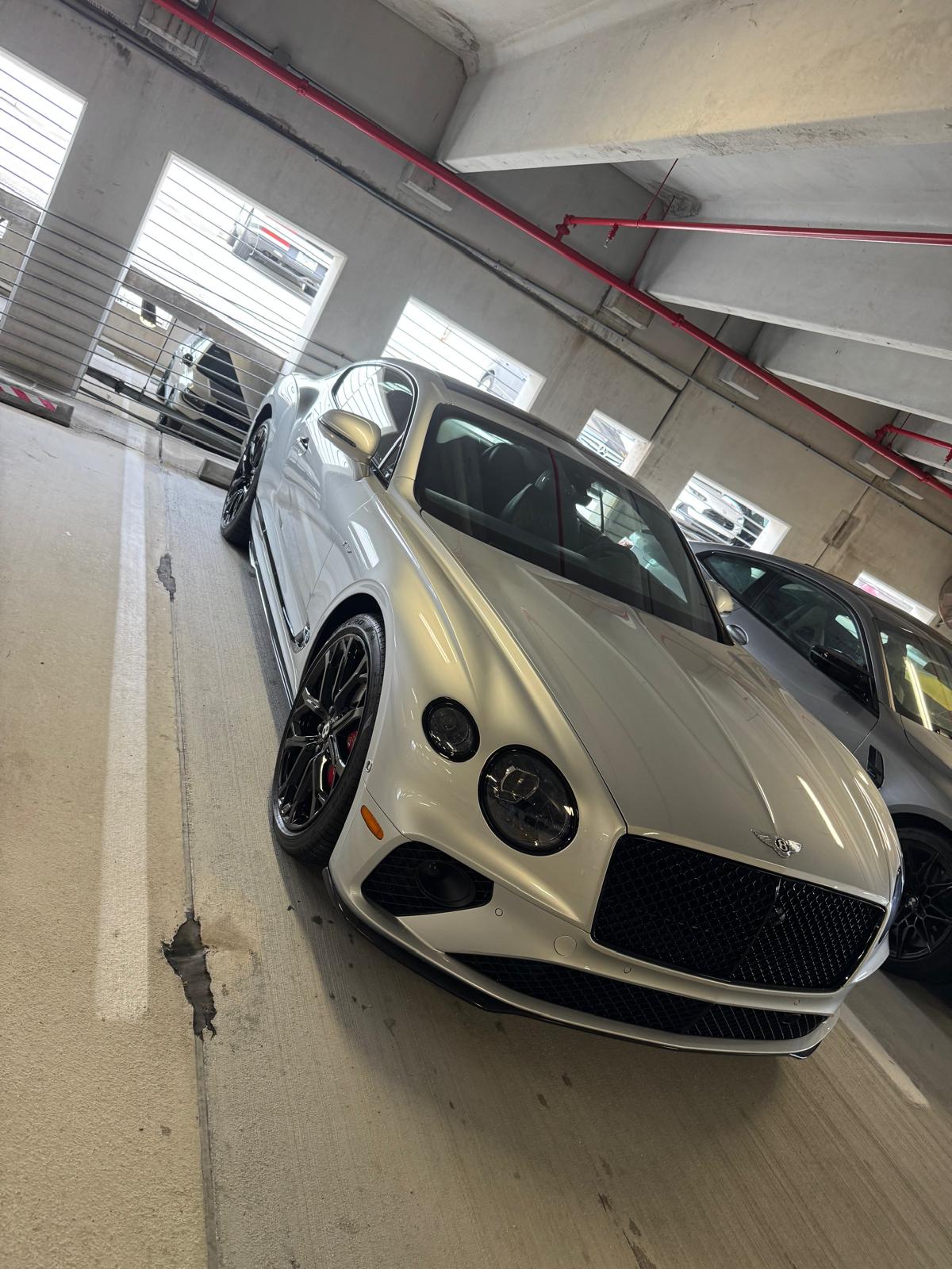 Detailed white Bentley in a premium parking location